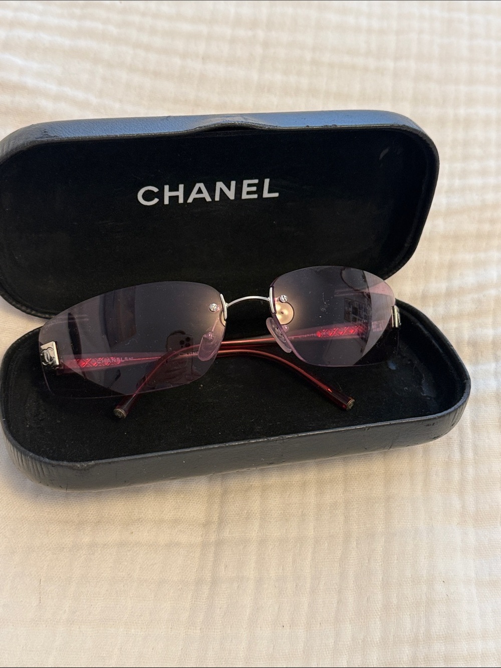 CHANEL Women's Rimless Sunglasses - Purple Lenses with Red Arms